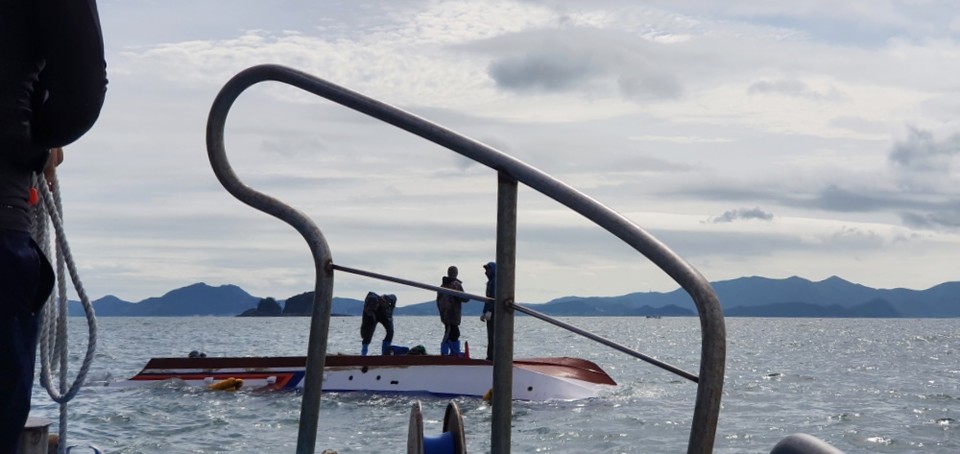 ▲전복된 배 위에서 구조를 기대리는 선원