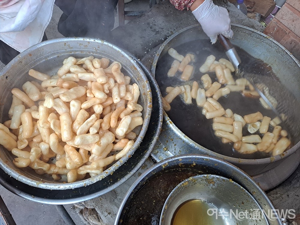 ▲ 땀이 맞춰지자 쌀과자를 솥단지에 적당량 부어 조청에 버무린다. ⓒ조찬현