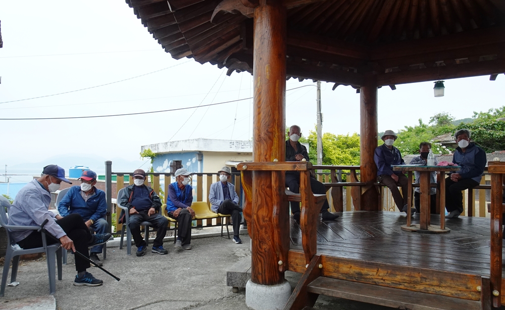 ▲경로당 앞 팔각정에서 이미용서비스 순서를 기다리는 어르신들.