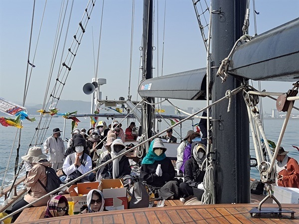 ▲ 수륙대재가 진행되는 동안 코리아나호 선상에서 기도하는 신도들 모습ⓒ오문수