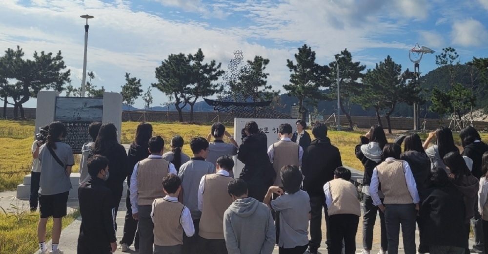 ▲ 이야포 상징 조형물 하늘꽃 앞에 선 학생들.