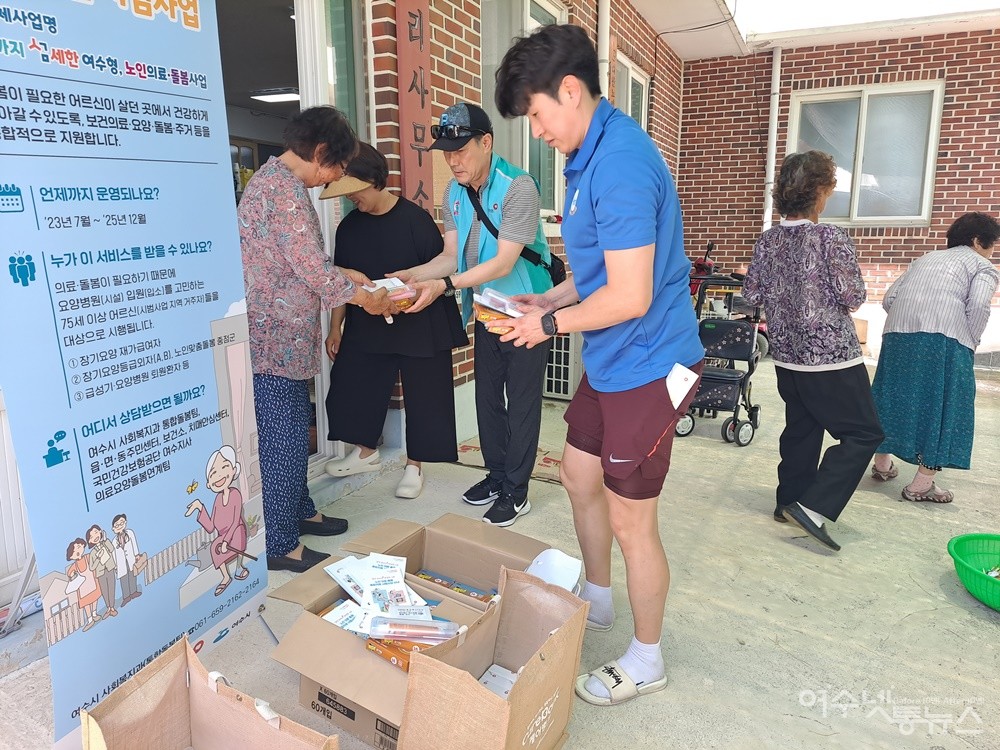 ▲여수시청 사회복지과와 국민건강보험공단 여수지사에서 준비한 선물을 마을 어르신들에게 나눠주고 있다. ⓒ조찬현