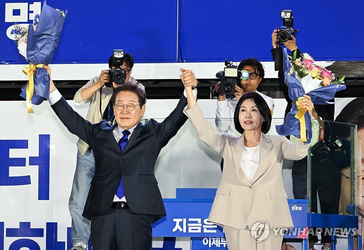 ▲ 시민들 향해 인사하는 이재명 후보 내외(서울=연합뉴스) 김주성 기자 = 제21대 대통령 당선이 확실시되는 더불어민주당 이재명 대선 후보와 부인 김혜경 여사가 4일 서울 여의도 국회 인근에서 당 주최로 열린 국민개표방송 행사에 참석해 꽃다발을 받고서 시민들을 향해 두 팔을 들어 인사하고 있다. 2025.6.4 [공동취재] utzza@yna.co.kr