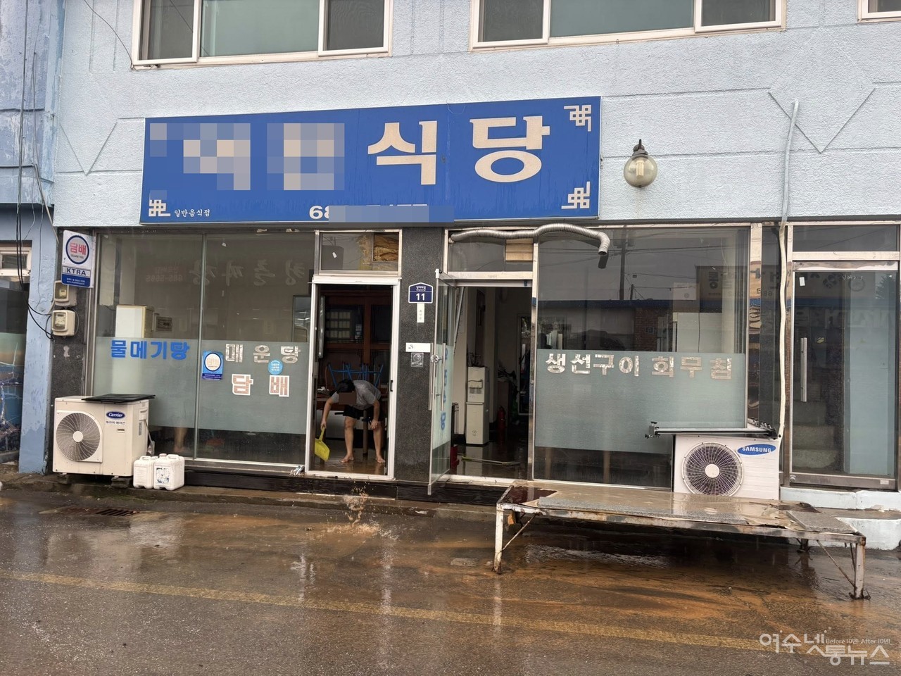 ▲ 한 식당 상인이 빗물에 잠긴 가게의 물을 퍼내고 있다. ⓒ최무경 도의원